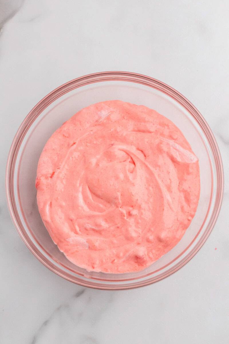 adding in the vanilla pudding to the Strawberry Jell-O.