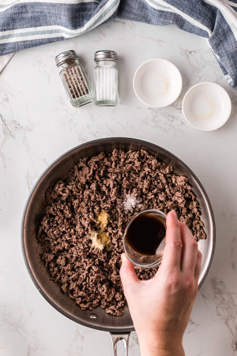 adding the seasoning and Worcestershire sauce to the beef.