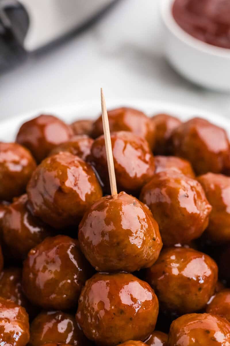 pile of meatballs with one with a toothpick in it.