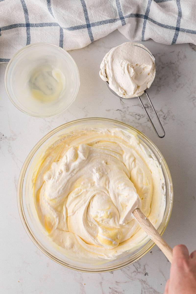 folding in the whipped topping with the banana pudding.
