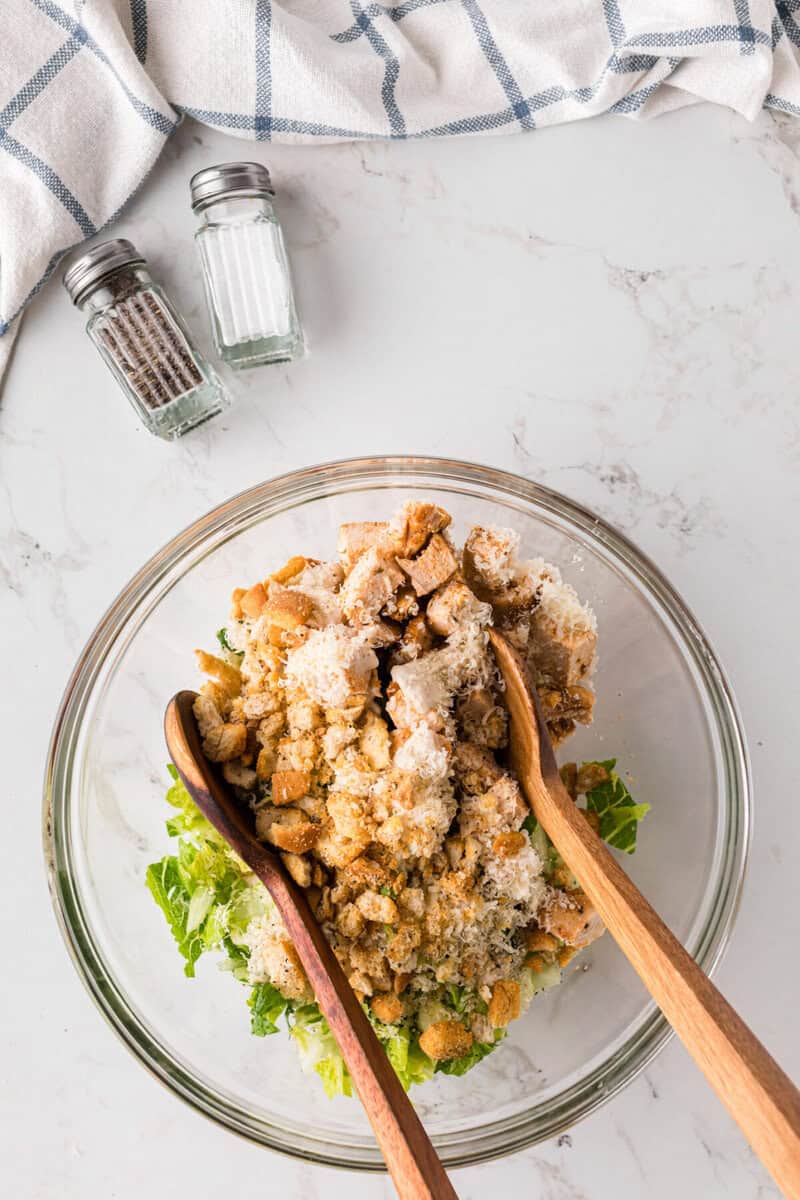 mixing the ingredients together in a large glass bowl.
