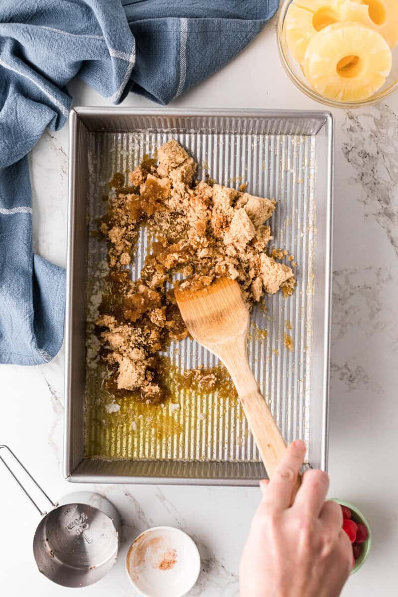 mixing the melted butter, brown sugar and cinnamon on the bottom of the baking pan.