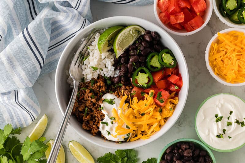 Taco Bowl with ingredients in bowls around it.