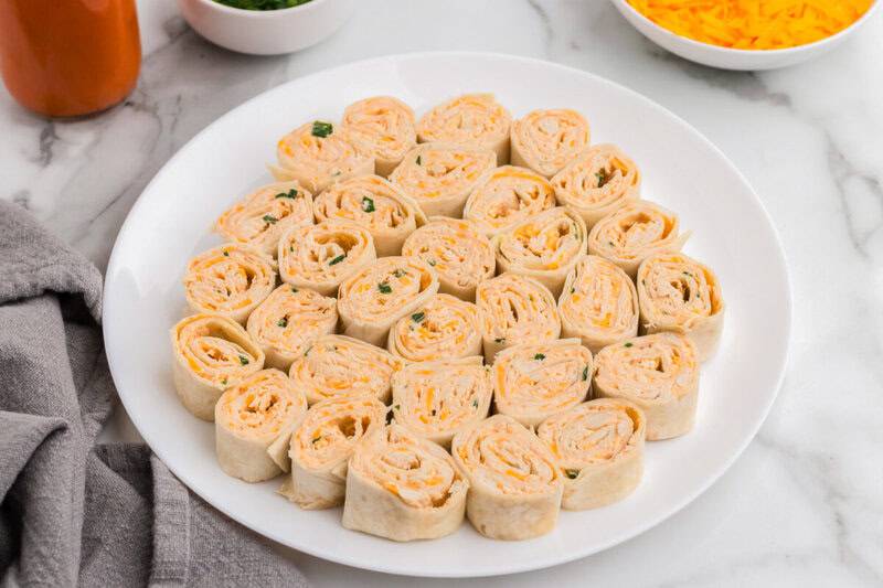 Buffalo Chicken Pinwheels arranged on a white serving plate.