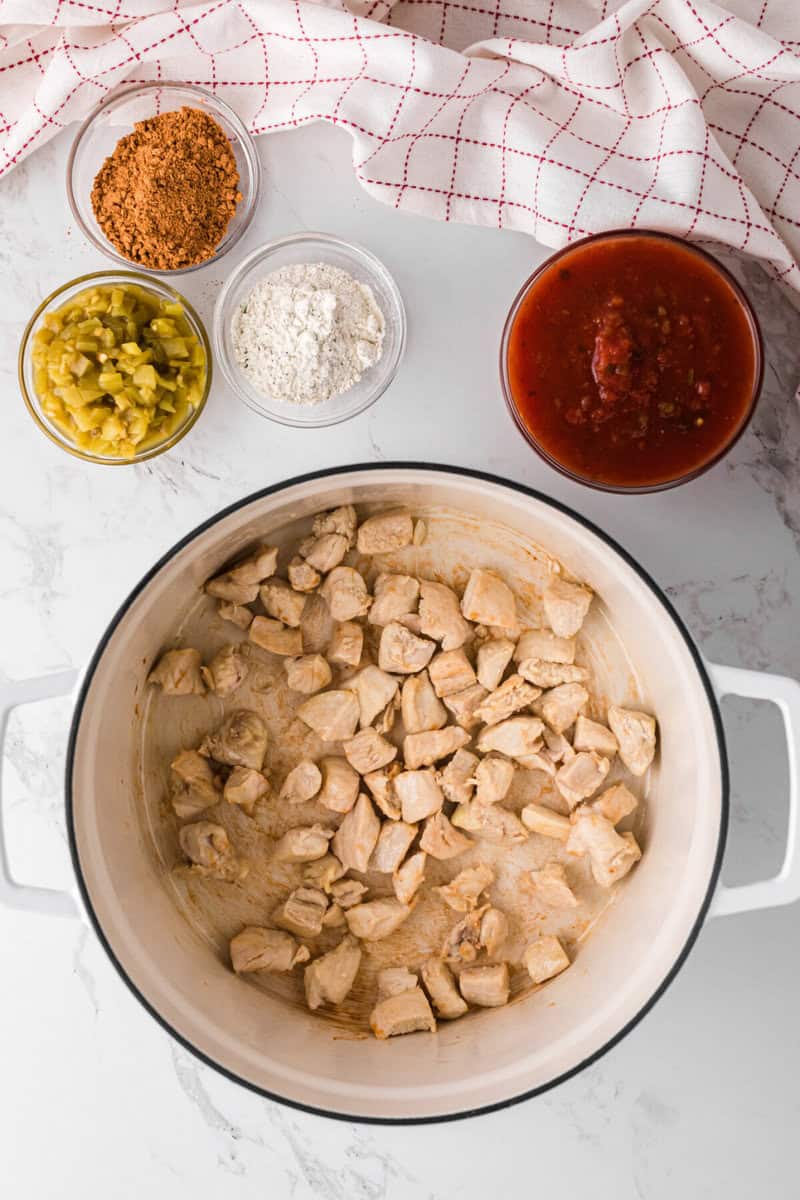 cooking the chicken in the bottom of the soup pot.