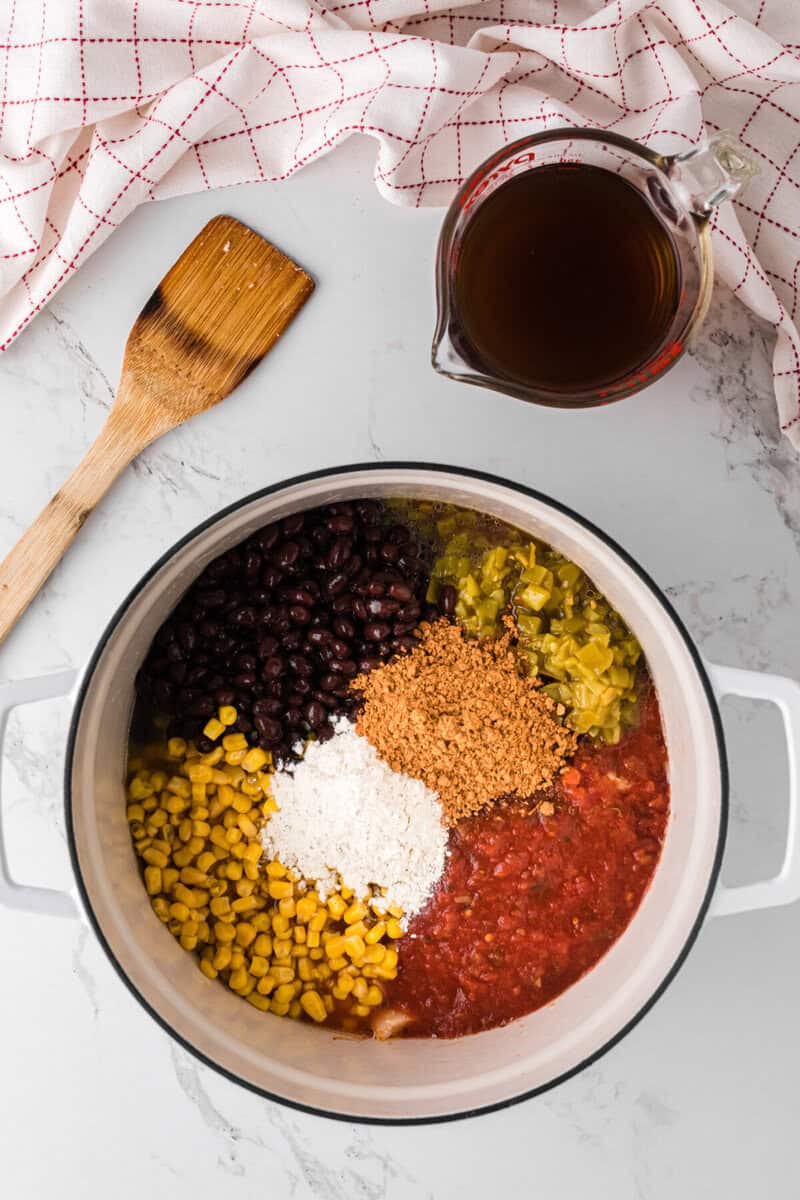 ingredients for the soup in the pot on top of the chicken.