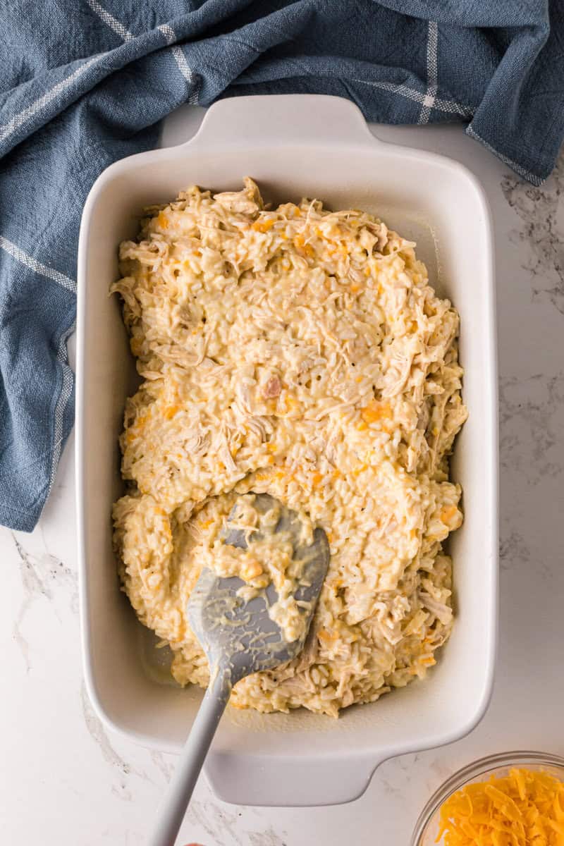 spreading the casserole mixture onto the bottom of the casserole dish.