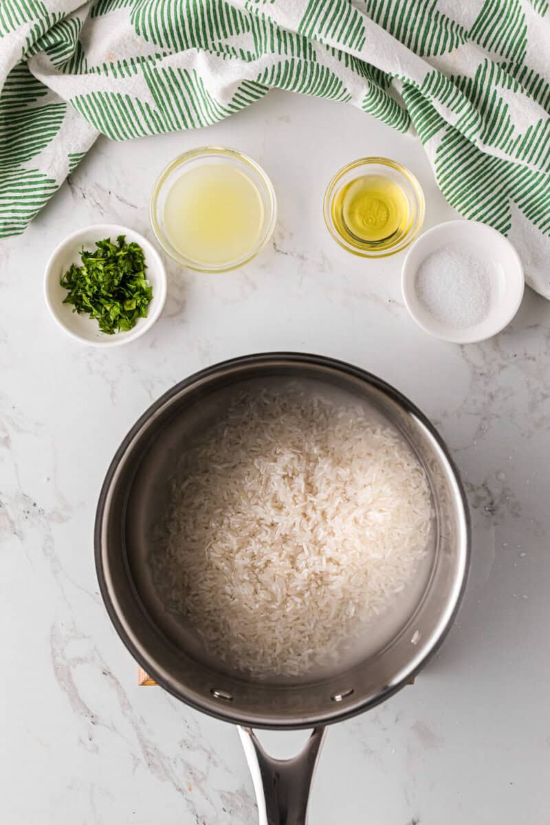 rice in a pan with water before cooking.