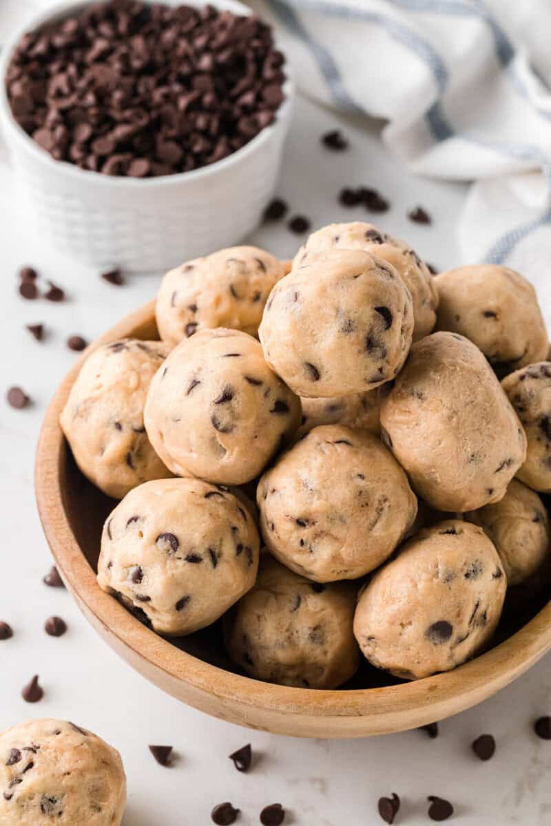 cookie dough balls served in a wooden bowl.