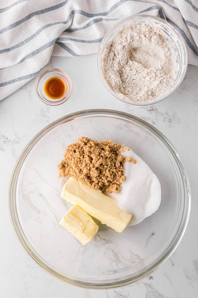 mixing the sugars and butter in a glass bowl.