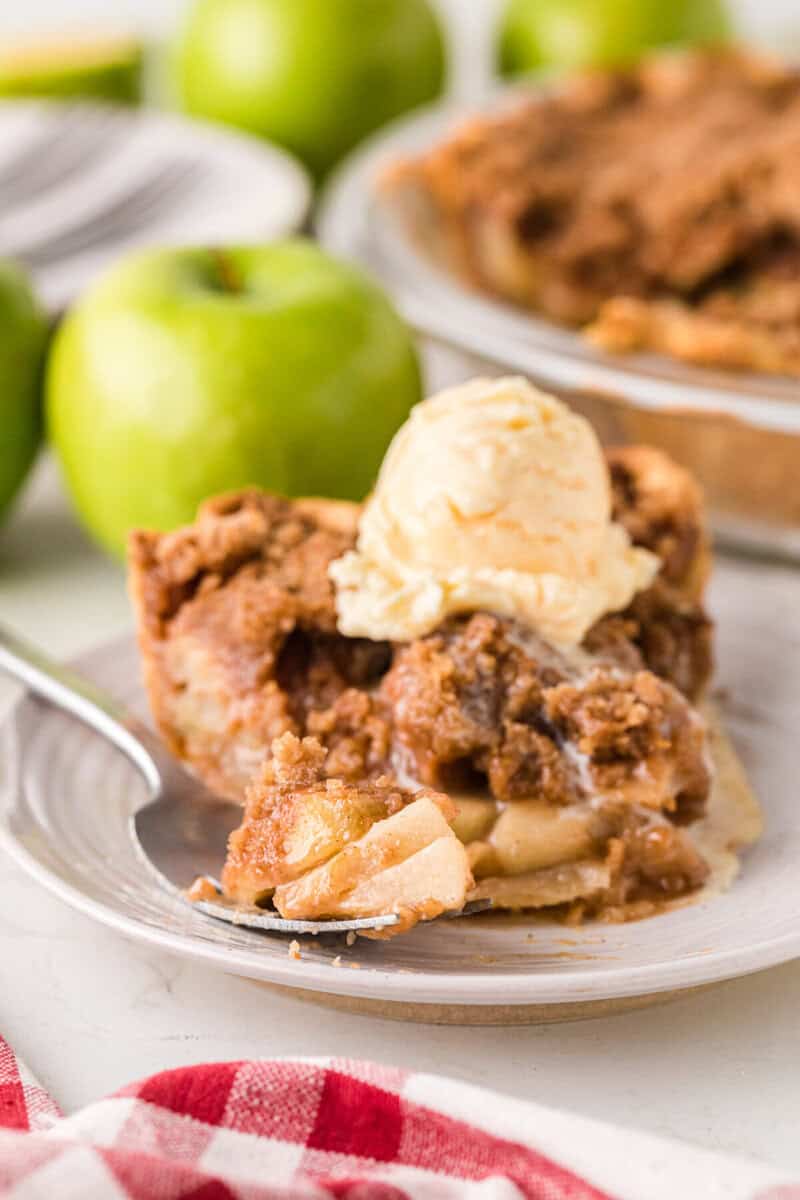 slice of the Dutch Apple Pie on a plate topped with ice cream.