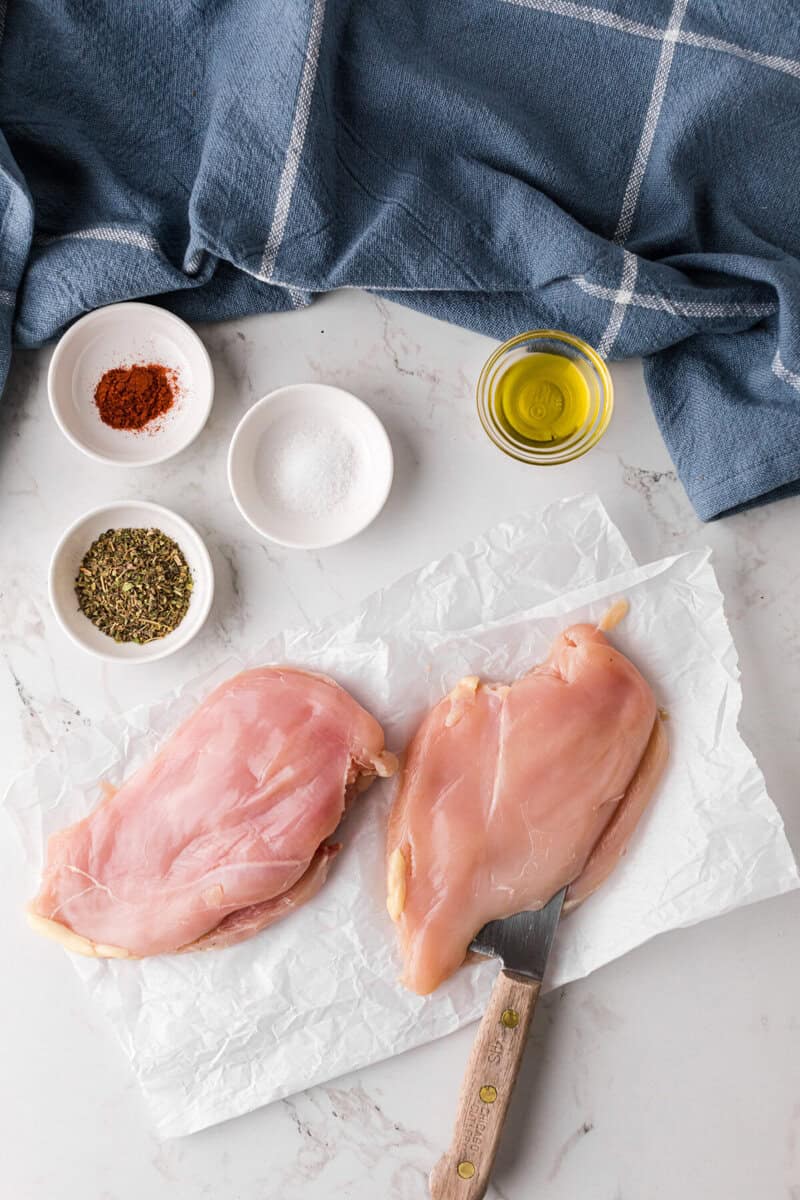 butterflying the chicken breasts to prepare them.