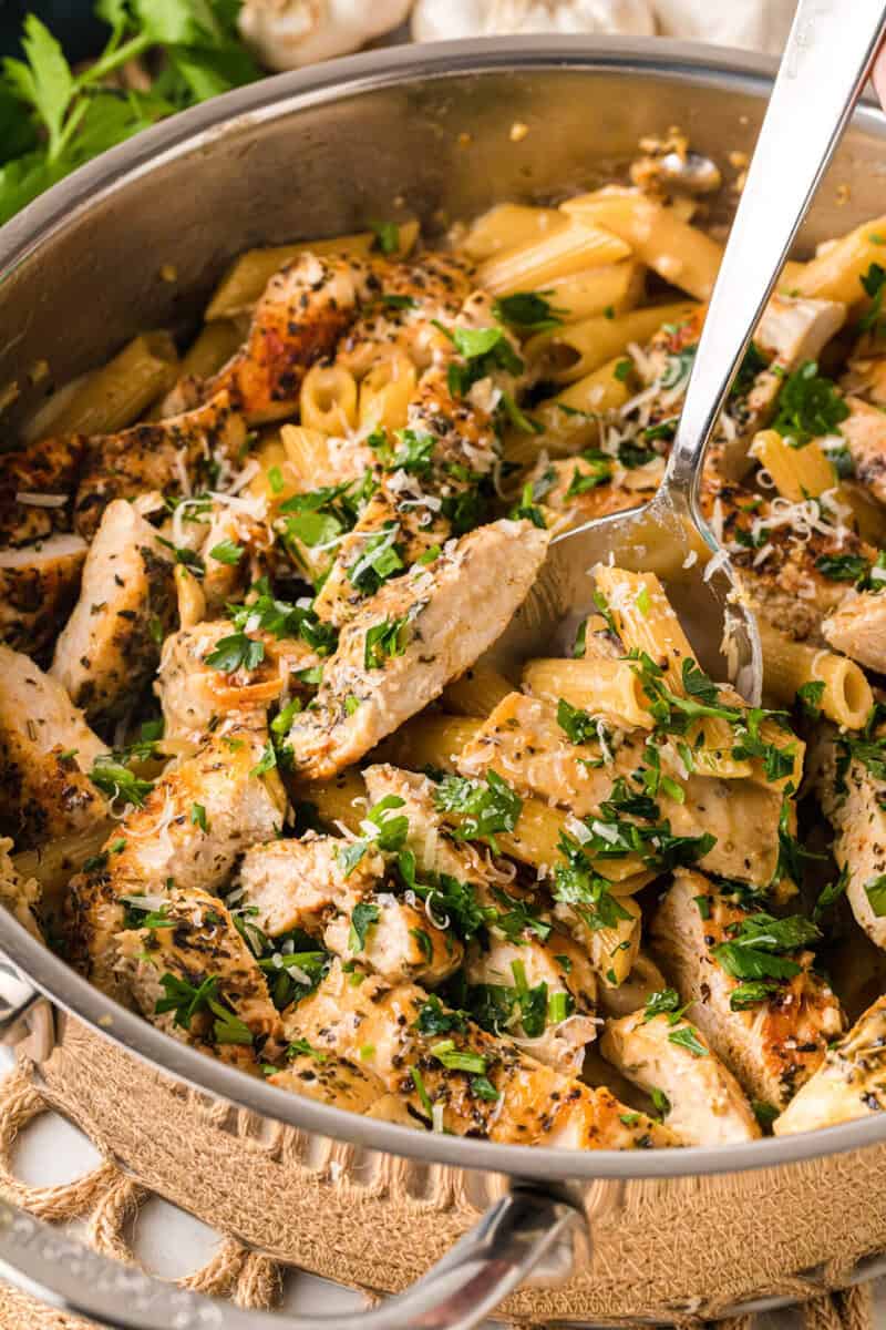 serving the pasta with a metal spoon.