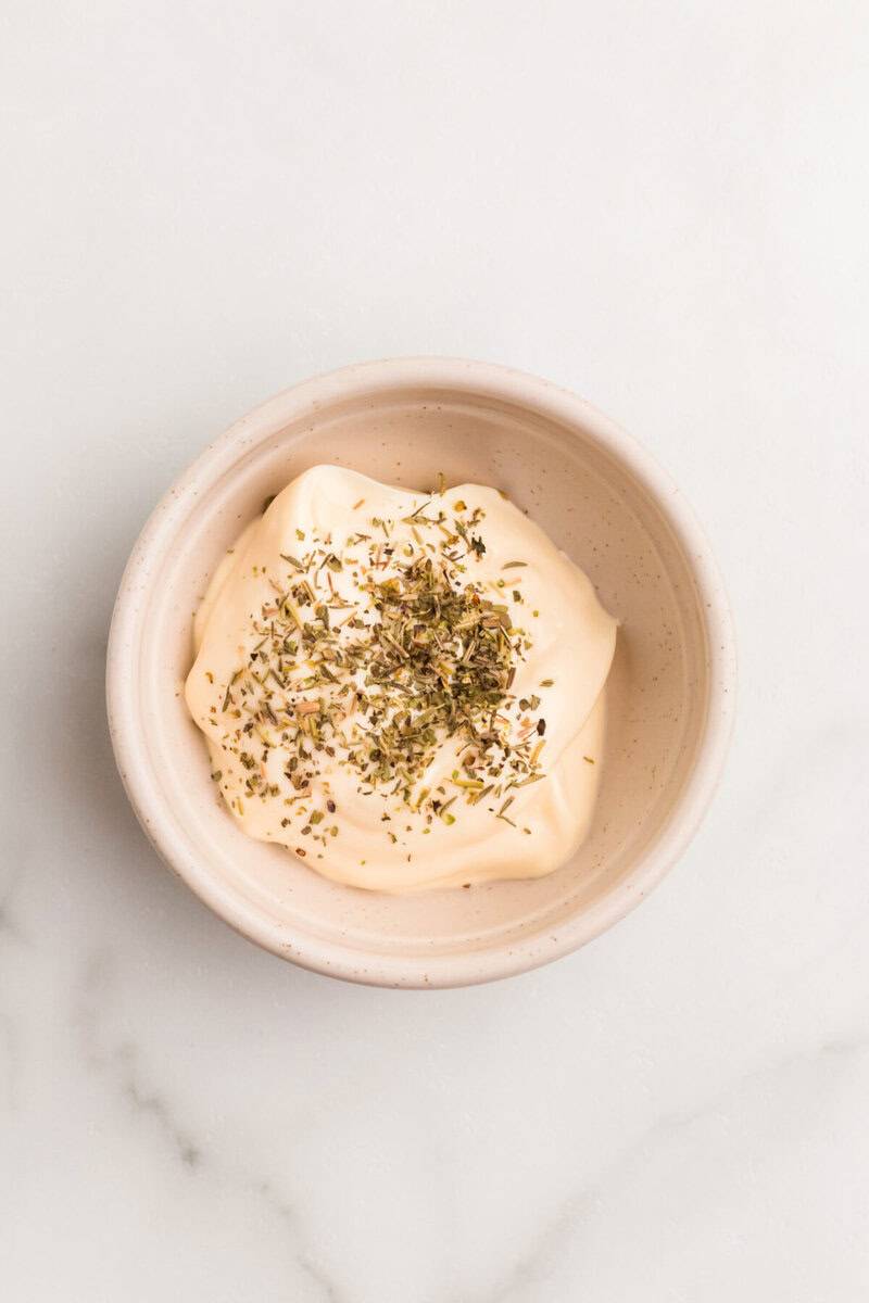 mayo and Italian Seasoning in a mixing bowl for the spread.