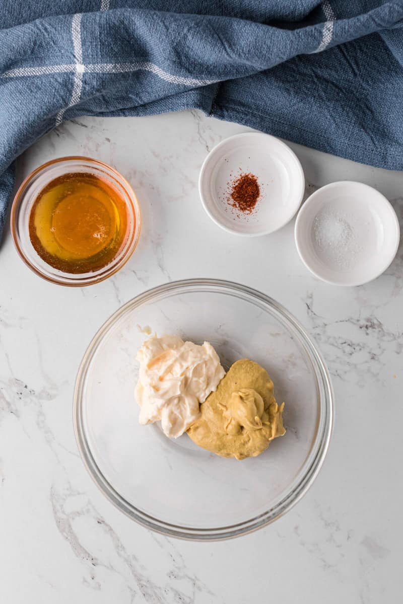 ingredients for the Honey Mustard dipping sauce in a glass bowl.