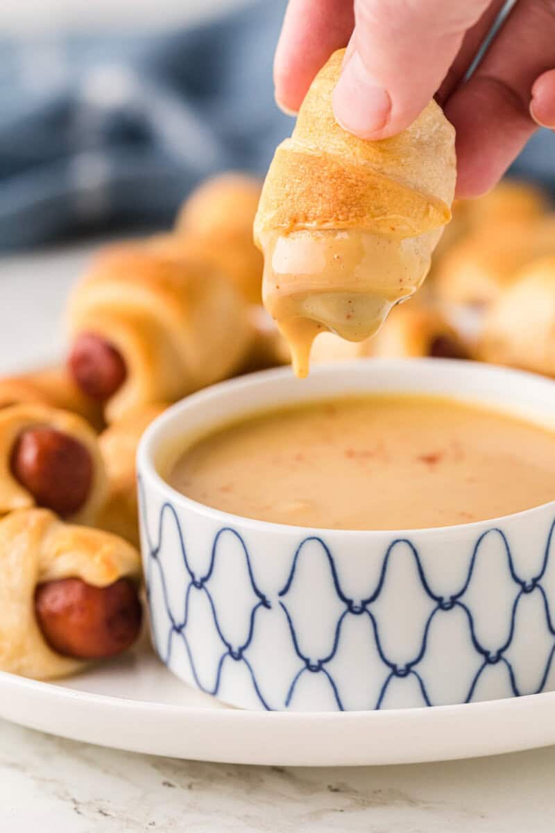 dipping a Pig in a Blanket into the Honey Mustard.