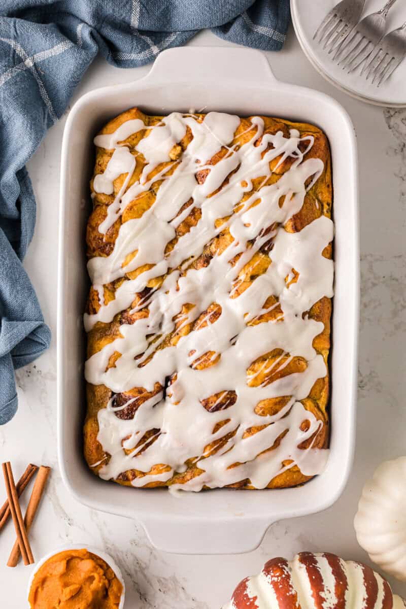 Pumpkin Cinnamon Roll Casserole in white casserole dish.
