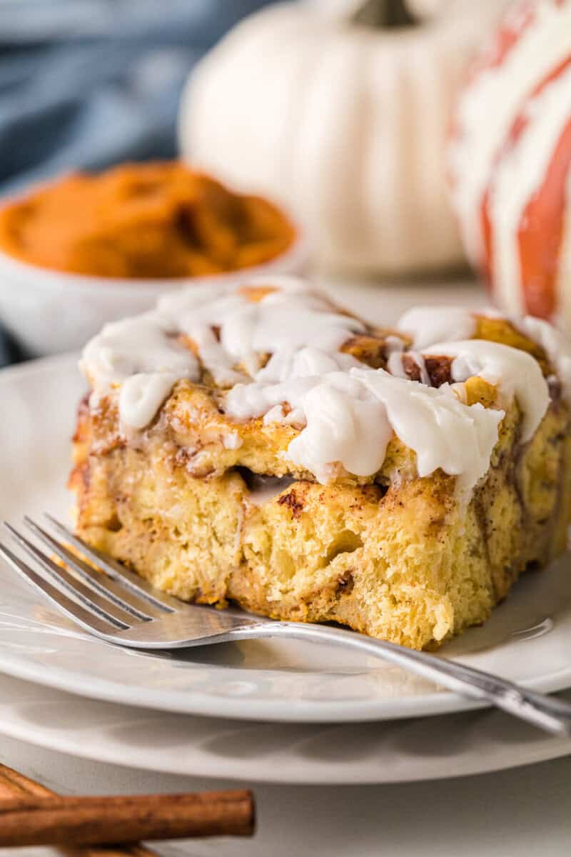 closeup of a slice of the cinnamon casserole served on a white plate.