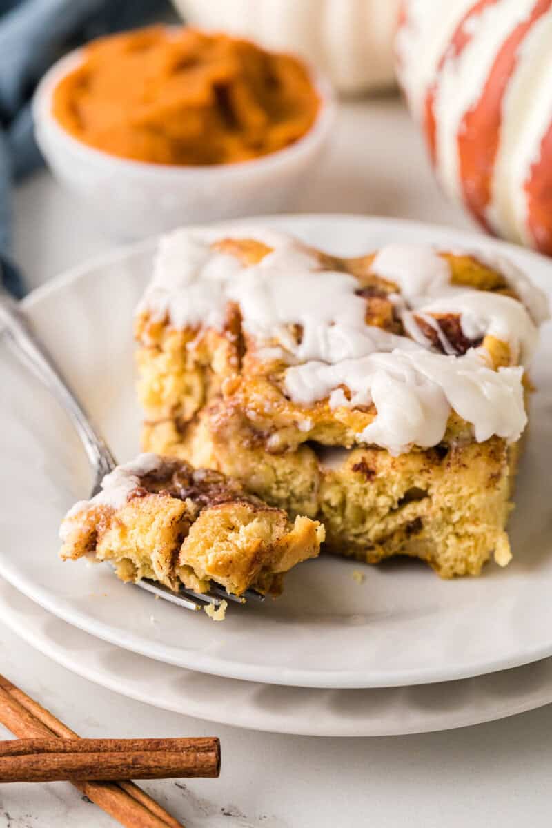 using a fork to take a bite of the casserole.