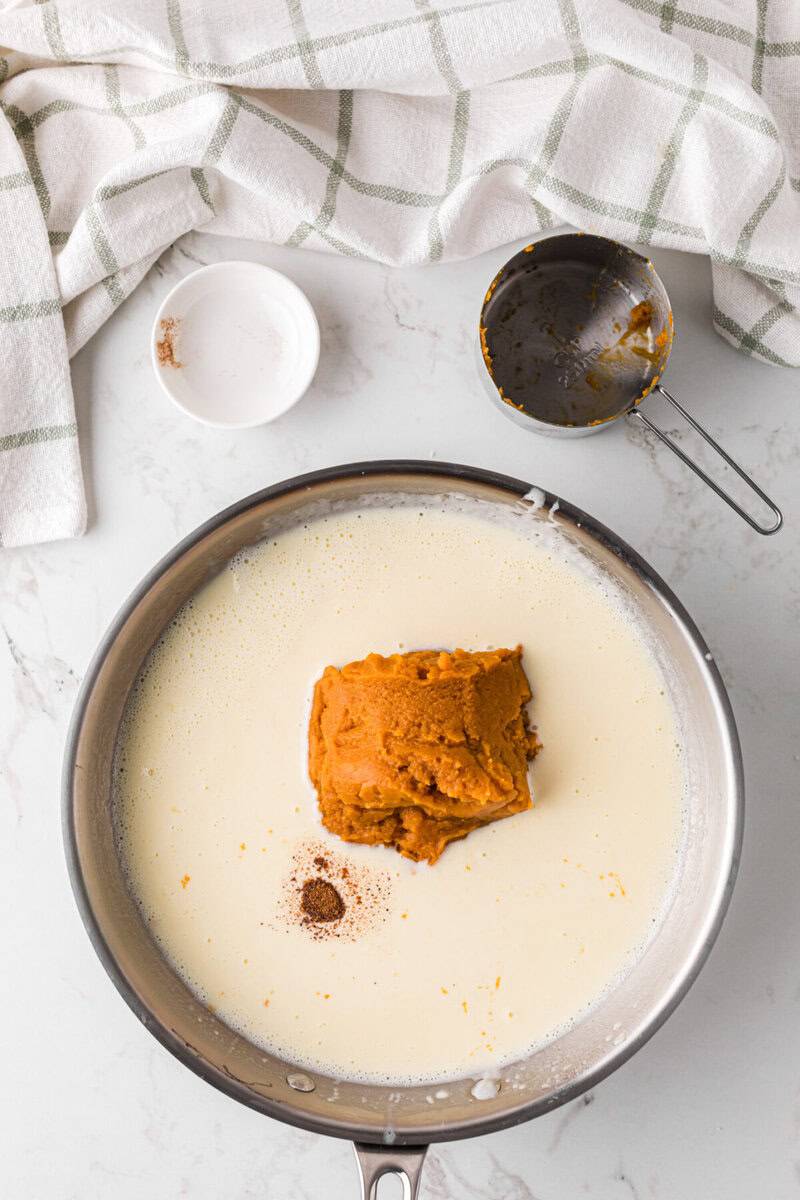 adding the pumpkin puree to the sauce.