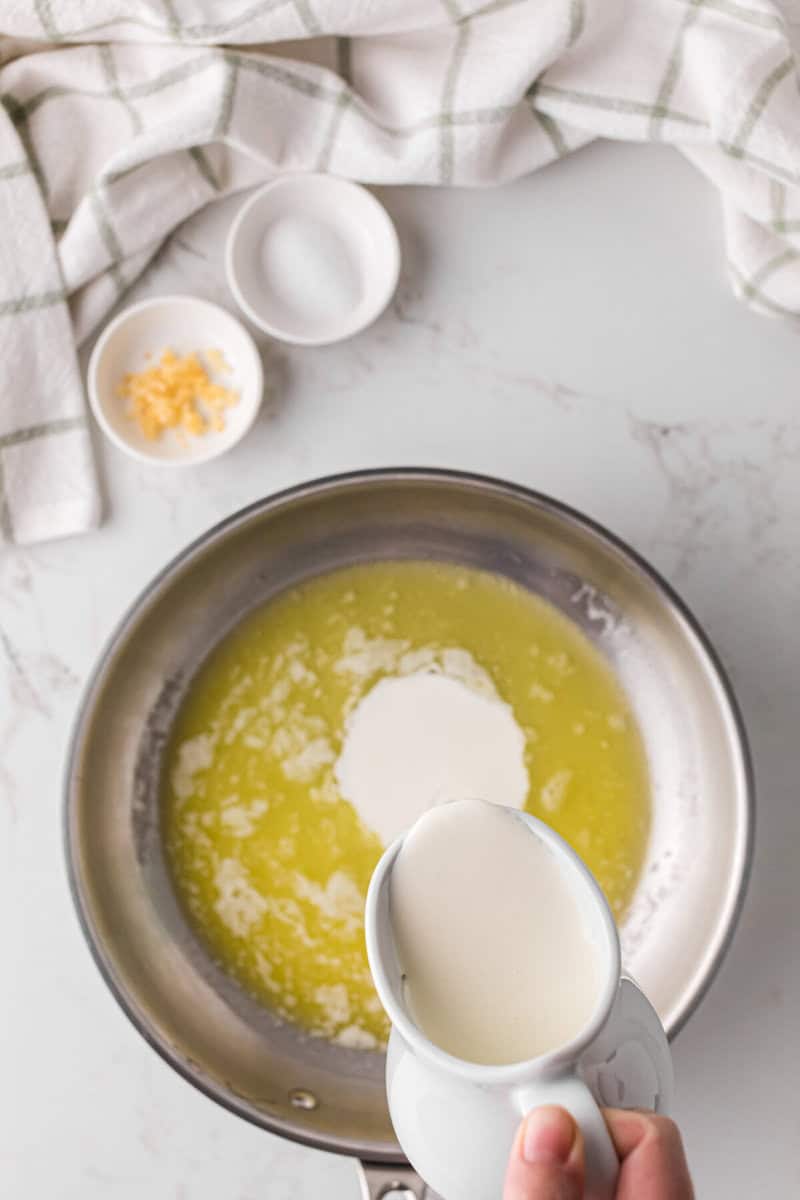 pouring the heavy cream into the melted butter.