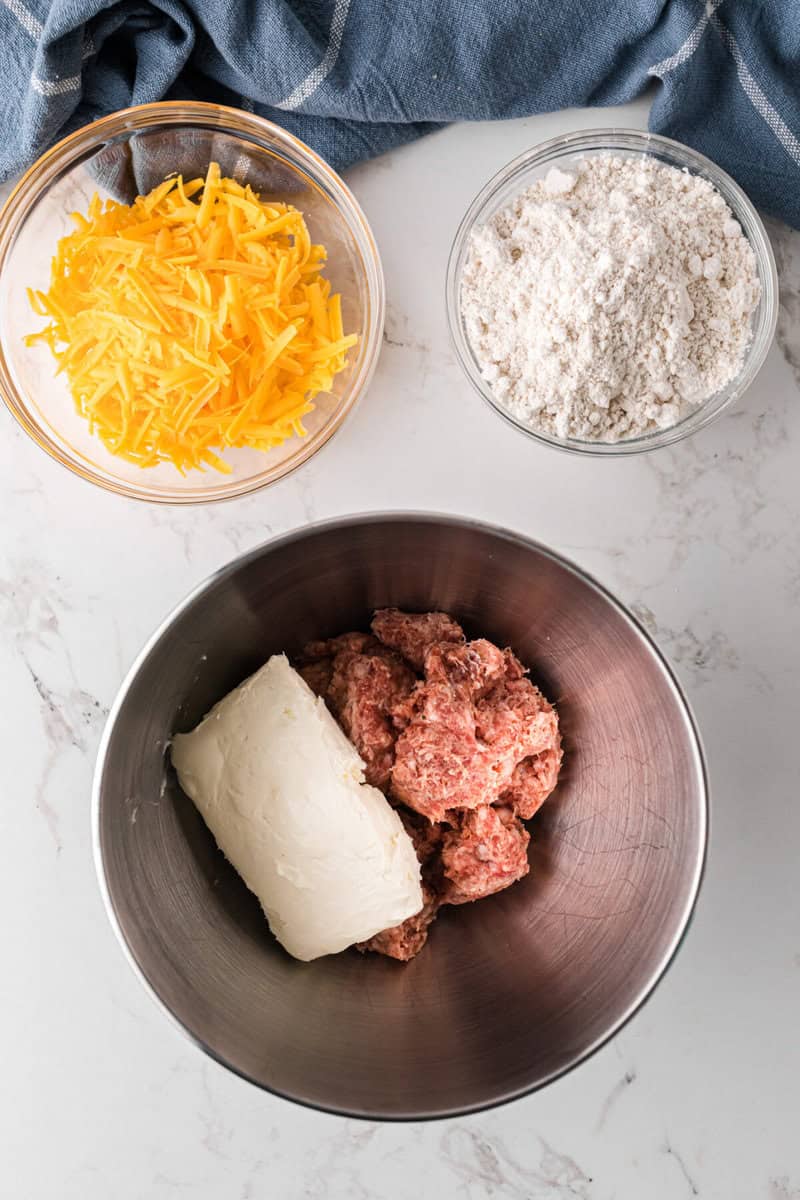 mixing the sausage and the cream cheese.
