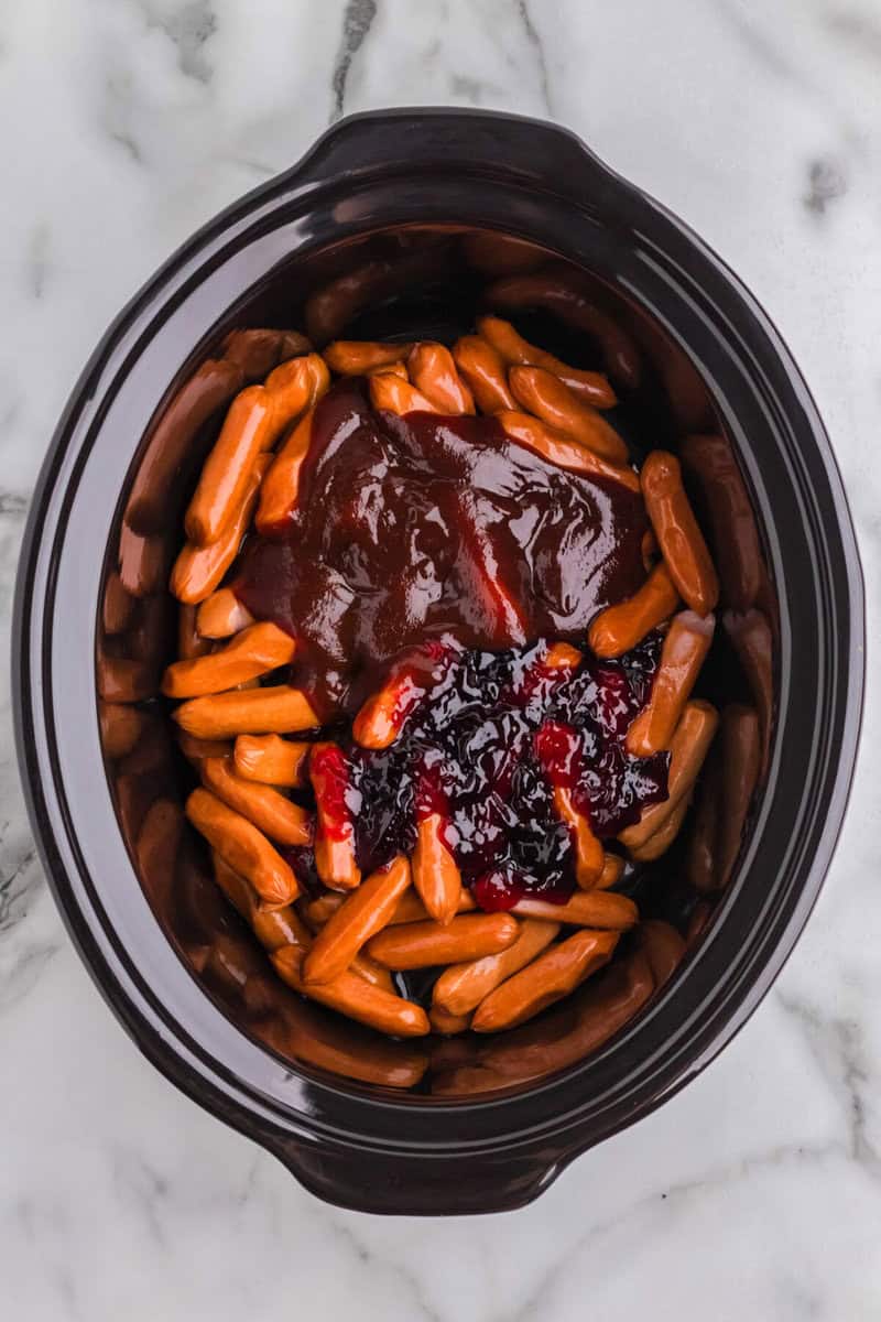 all ingredients in the slow cooker for the little smokies.