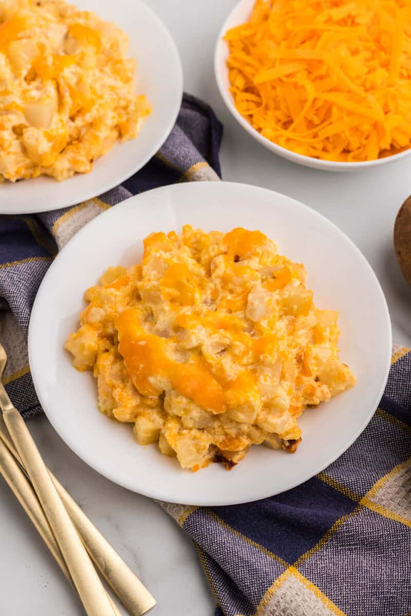 Slow Cooker Cheesy Potato Casserole served on a white plate.