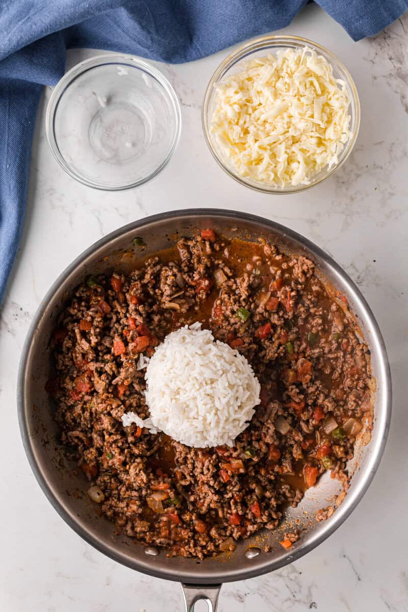 adding the rice to the meat filling.