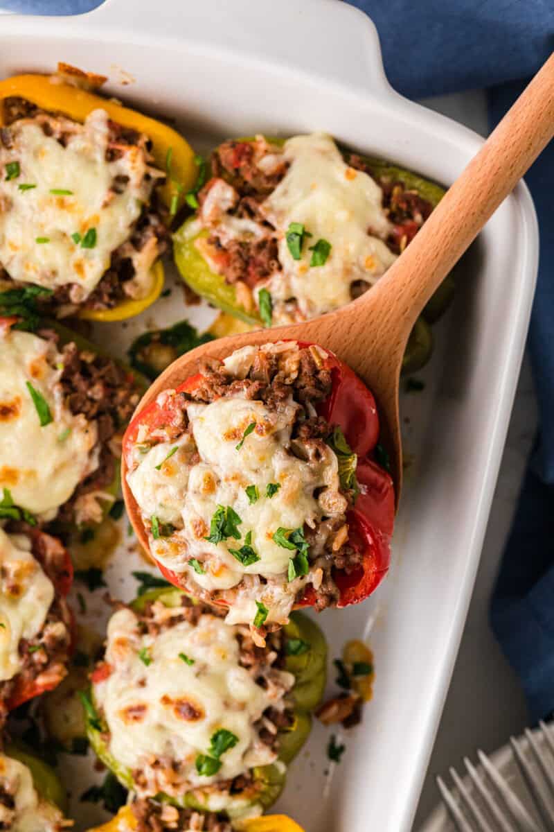serving a Stuffed Pepper with a wooden spoon.