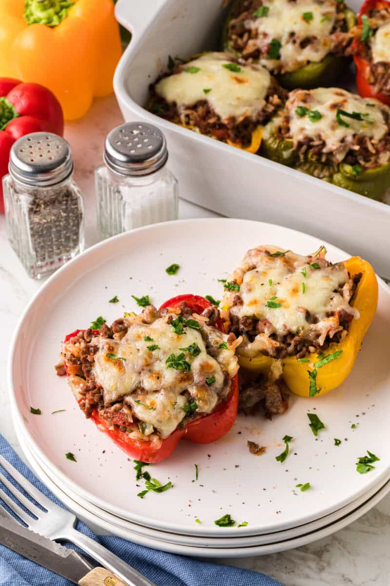 two Stuffed Peppers served on a white plate.