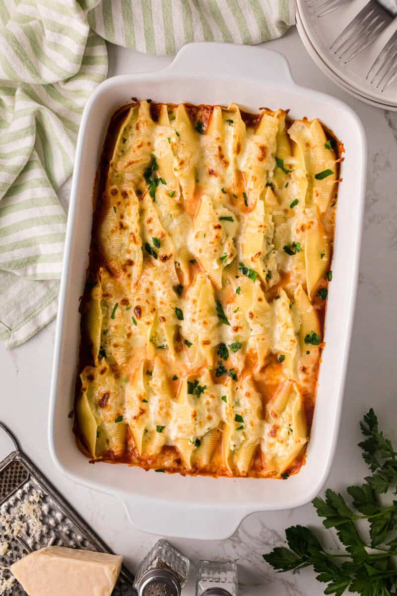 Baked Stuffed Shells in a white baking dish.