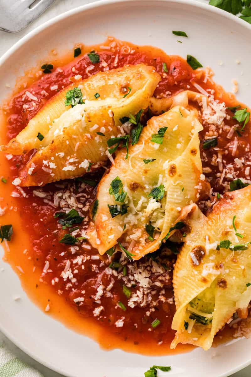 top-down view of the stuffed shells served on a white plate.