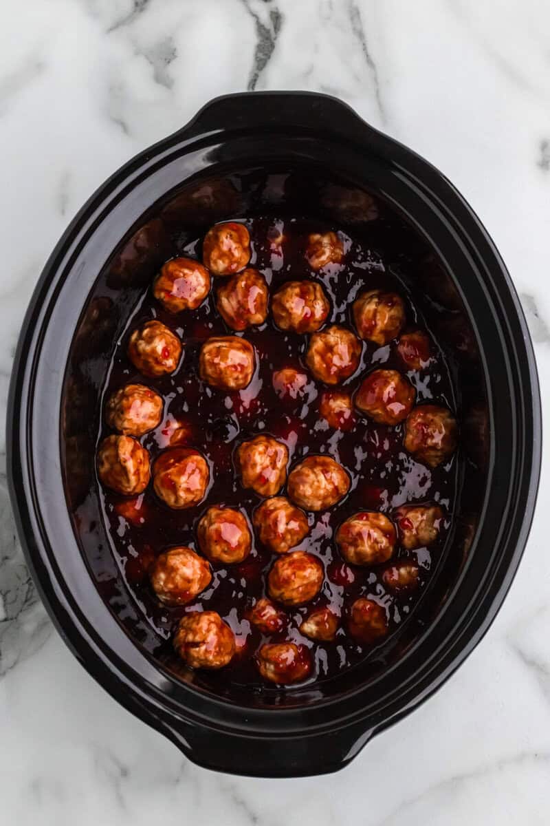 meatballs added to the slow cooker.