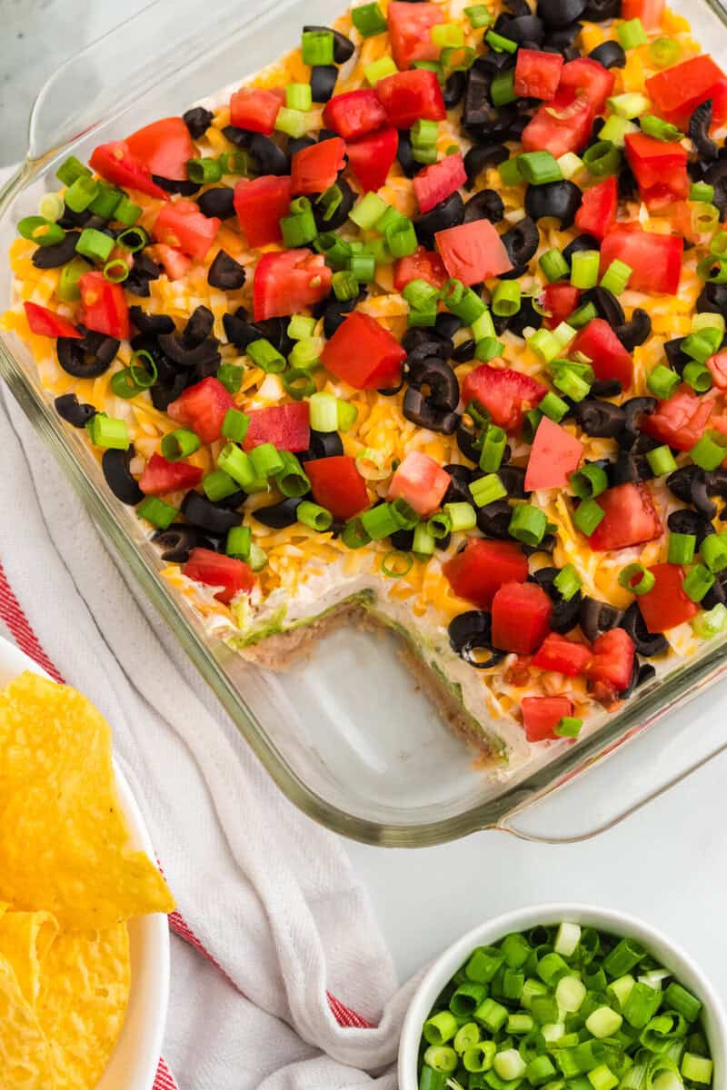 top-down view of the 5 Layer Dip with some of it served out of the dish.