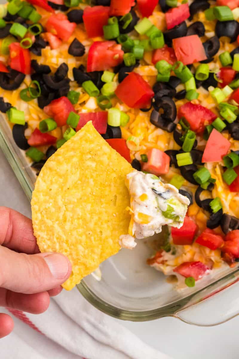 closeup of the 5 Layer Dip on a tortilla chip.