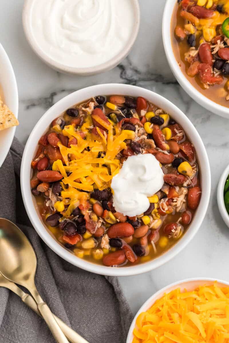 top-down view of the Taco Soup served in a white bowl.