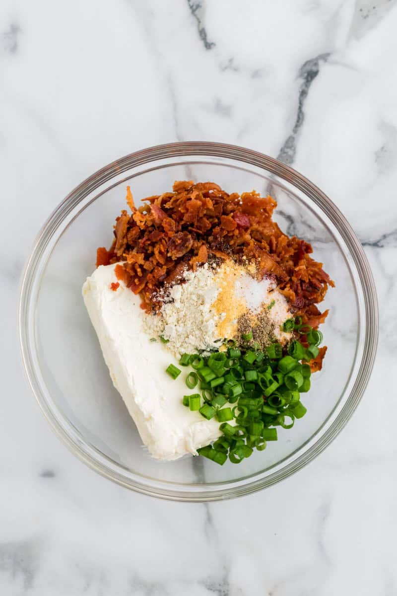 ingredients for the cheese ball in a glass mixing bowl.