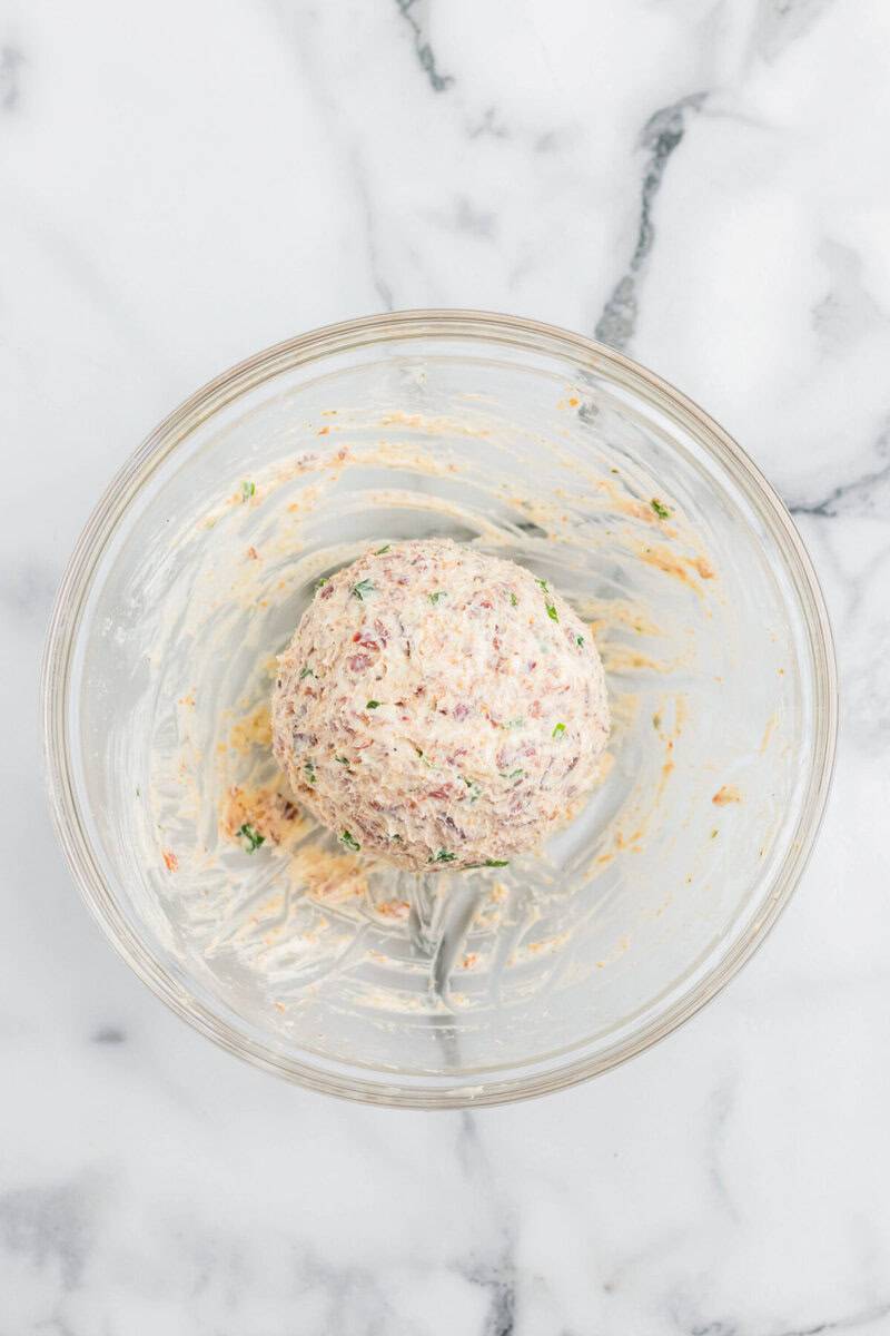 the bacon ranch cheese ball formed in the glass bowl.