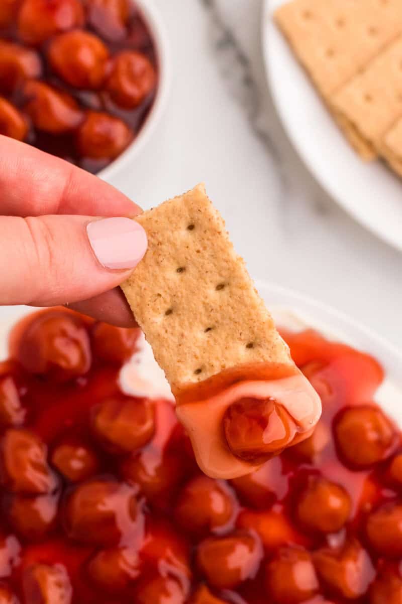 closeup of the Cherry Cheesecake Dip on a graham cracker.