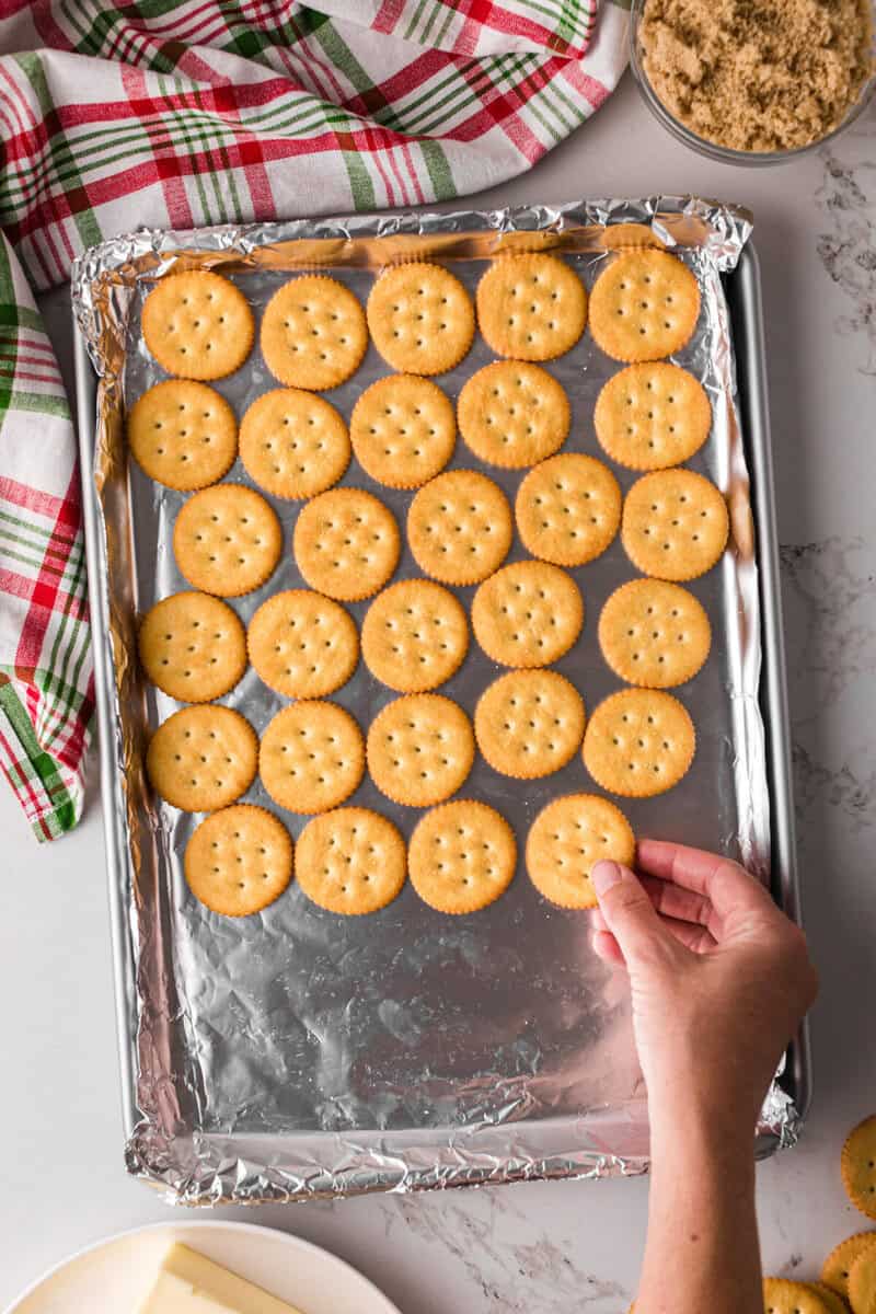 placing the crackers on a baking sheet lined with tinfoil.