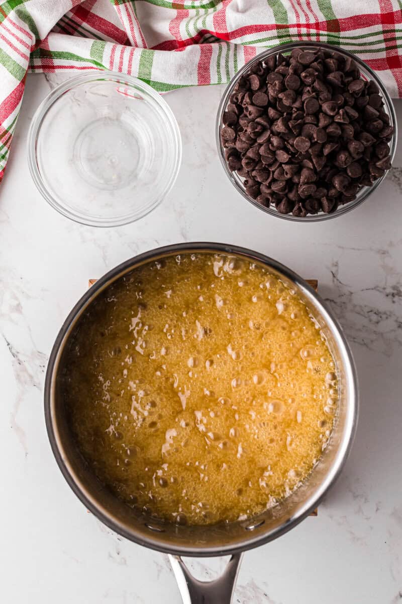 melting the butter and sugar together in a saucepan.