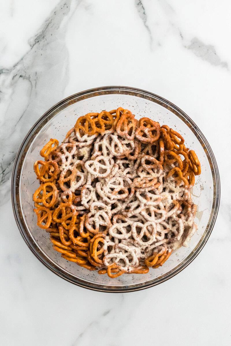 seasoning on top of the pretzels in the bowl.
