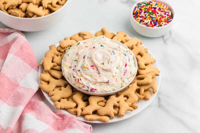 Funfetti Dip served in a bowl with animal crackers.