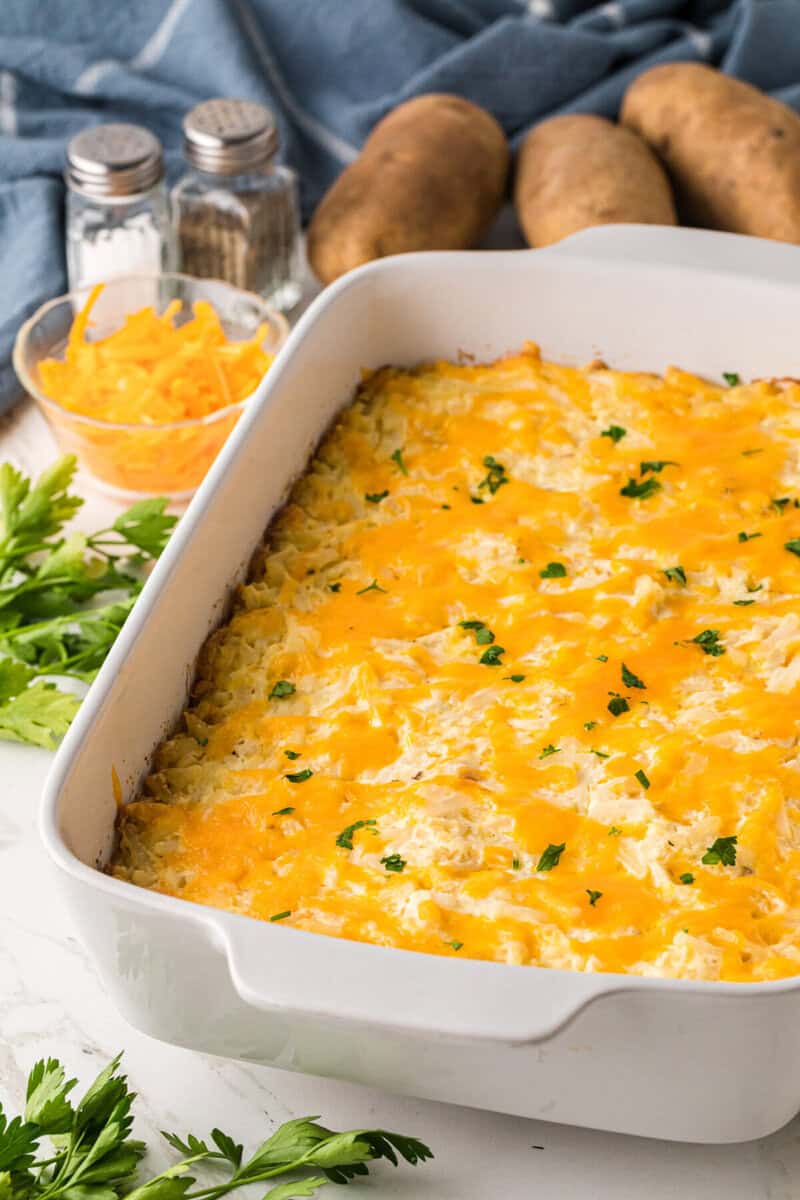 baked hashbrown casserole in white casserole dish.