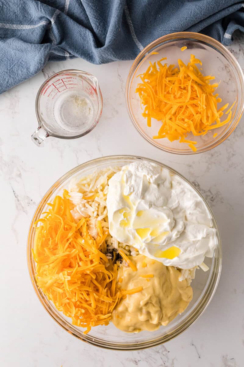 ingredients for the hashbrown casserole in a large mixing bowl.
