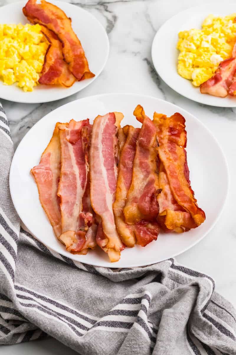 oven baked bacon served with eggs.