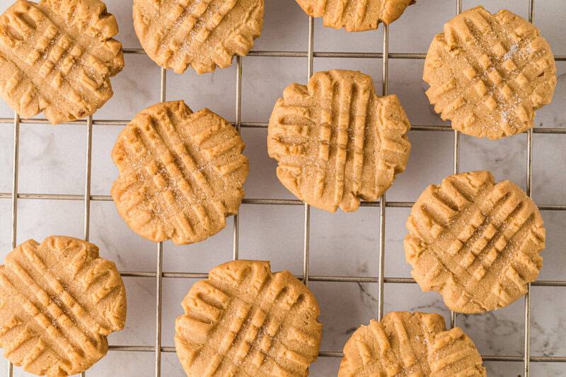 top-down view of the peanut butter cookies on a wire cooling rack.