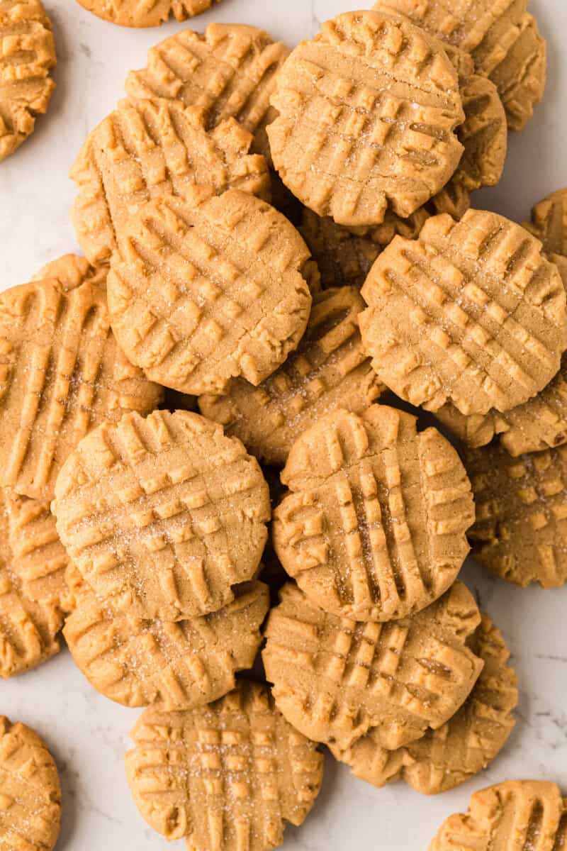 peanut butter cookies stacked on the counter.