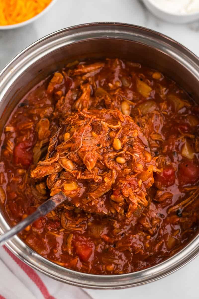 serving the Pulled Pork Chili out of the pot with a ladle.